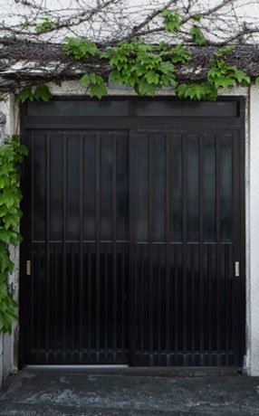 Puerta de herrería elaborada con lamina pintada de color negro